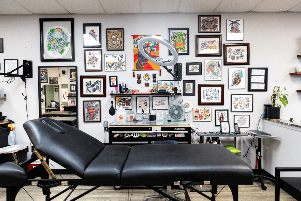 Tattoo Chair With Work Station and Hanging Art Behind It