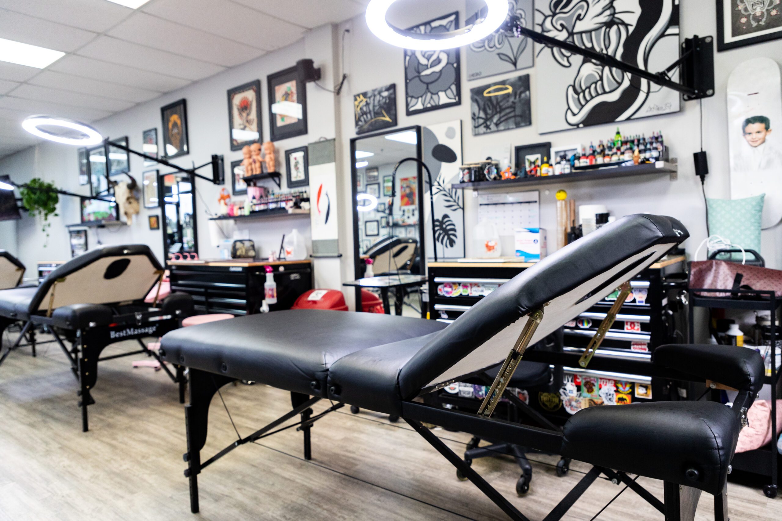 Tattoo Work Stations with Ring Lights Hanging Over Tattoo Chairs